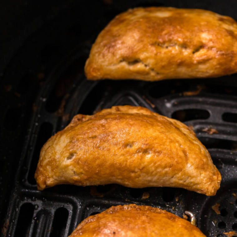 Crispy golden brown beef empanadas fresh from the air fryer basket