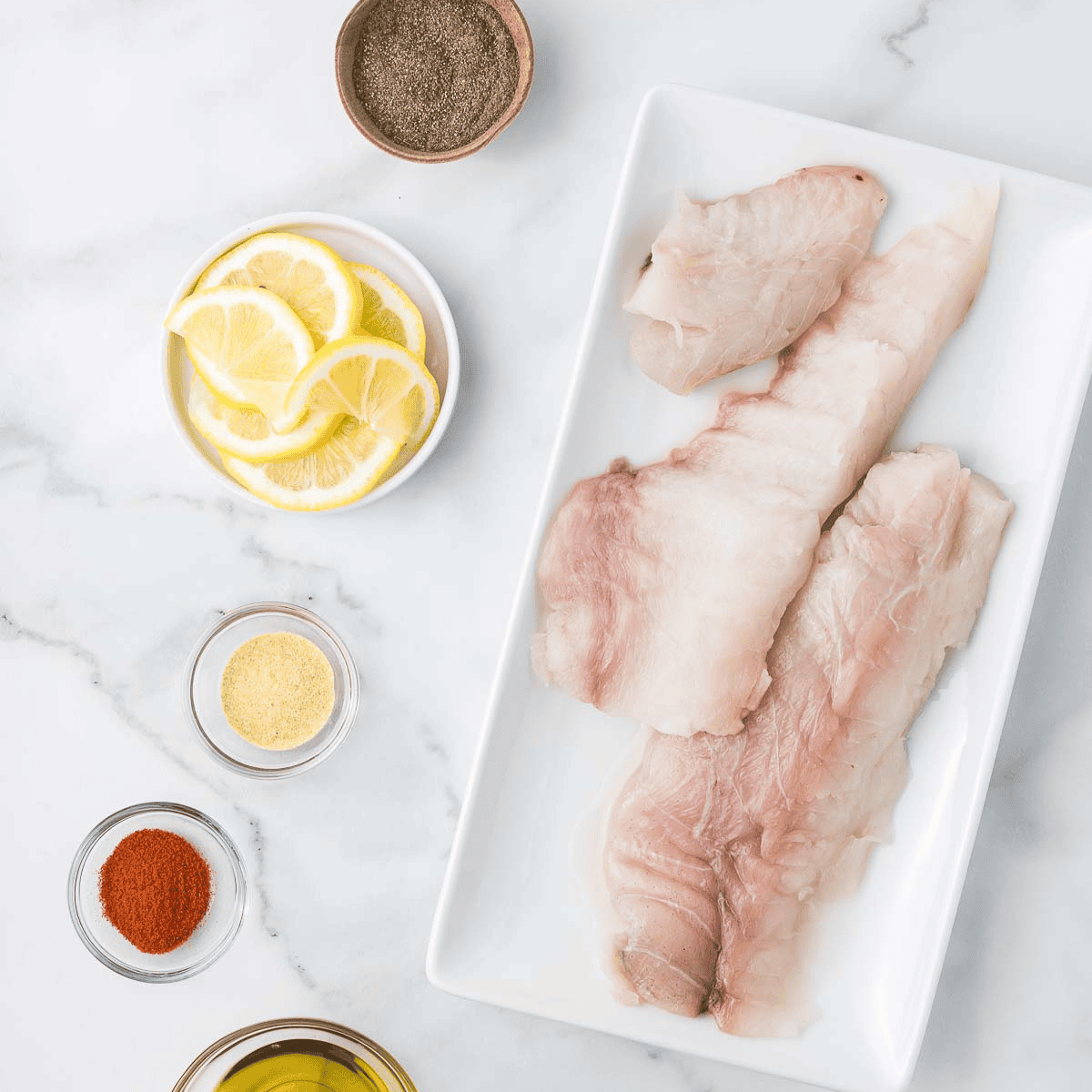 Air Fryer Branzino (Whole Or Fillets) ingredients on kitchen table.