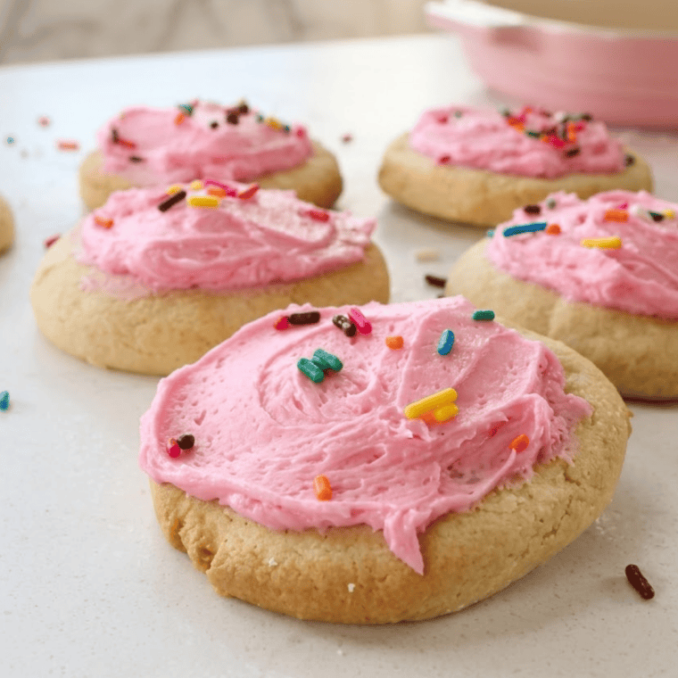 Plate of soft and chewy Air Fryer Copycat Lofthouse Cookies with colorful frosting and sprinkles.