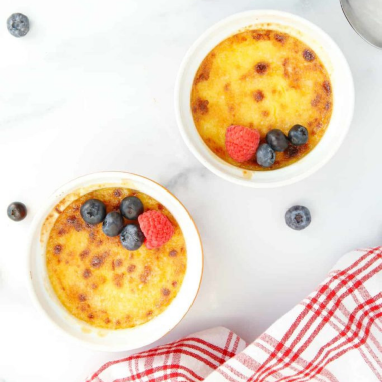 Air fryer creme brulee in a white ramekin with a cracked caramelized sugar top