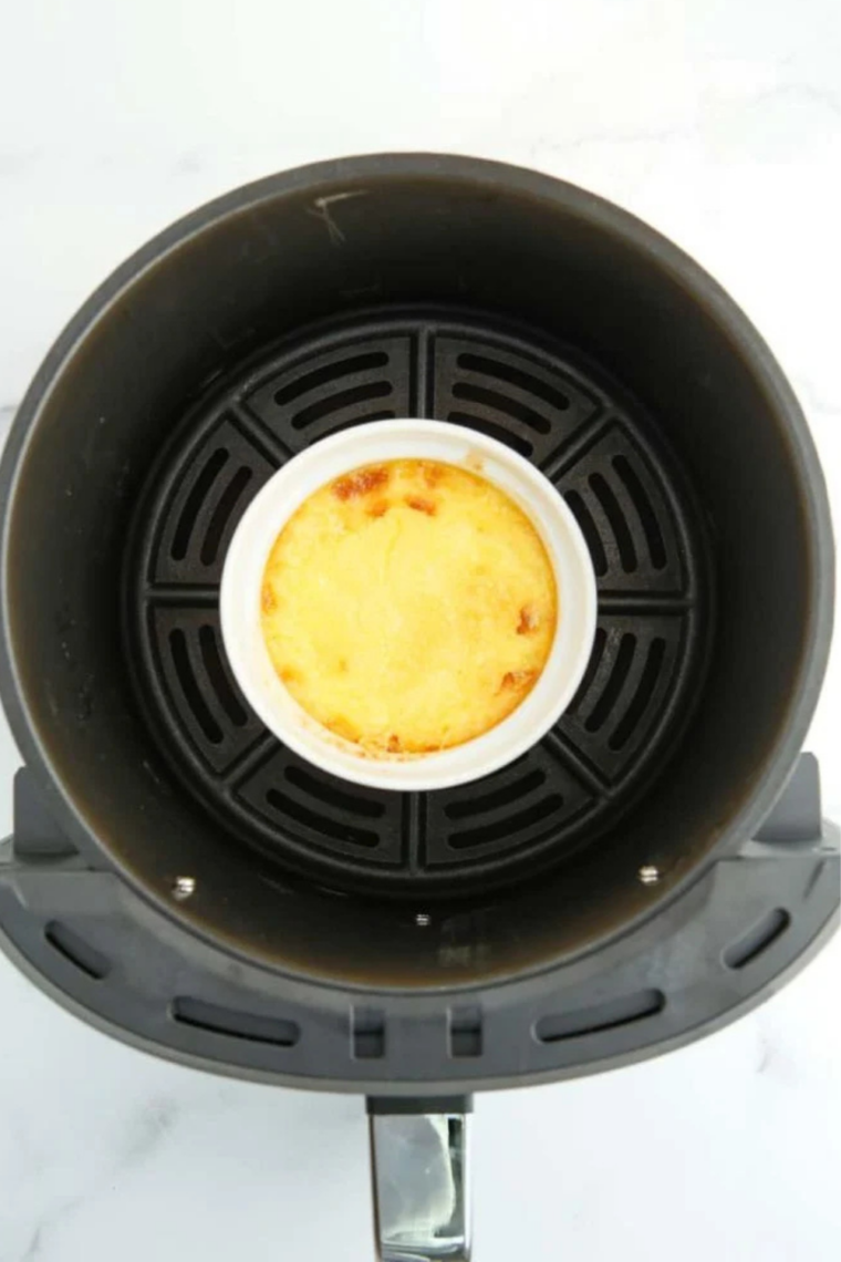 Kitchen torch caramelizing sugar on top of air fryer creme brulee