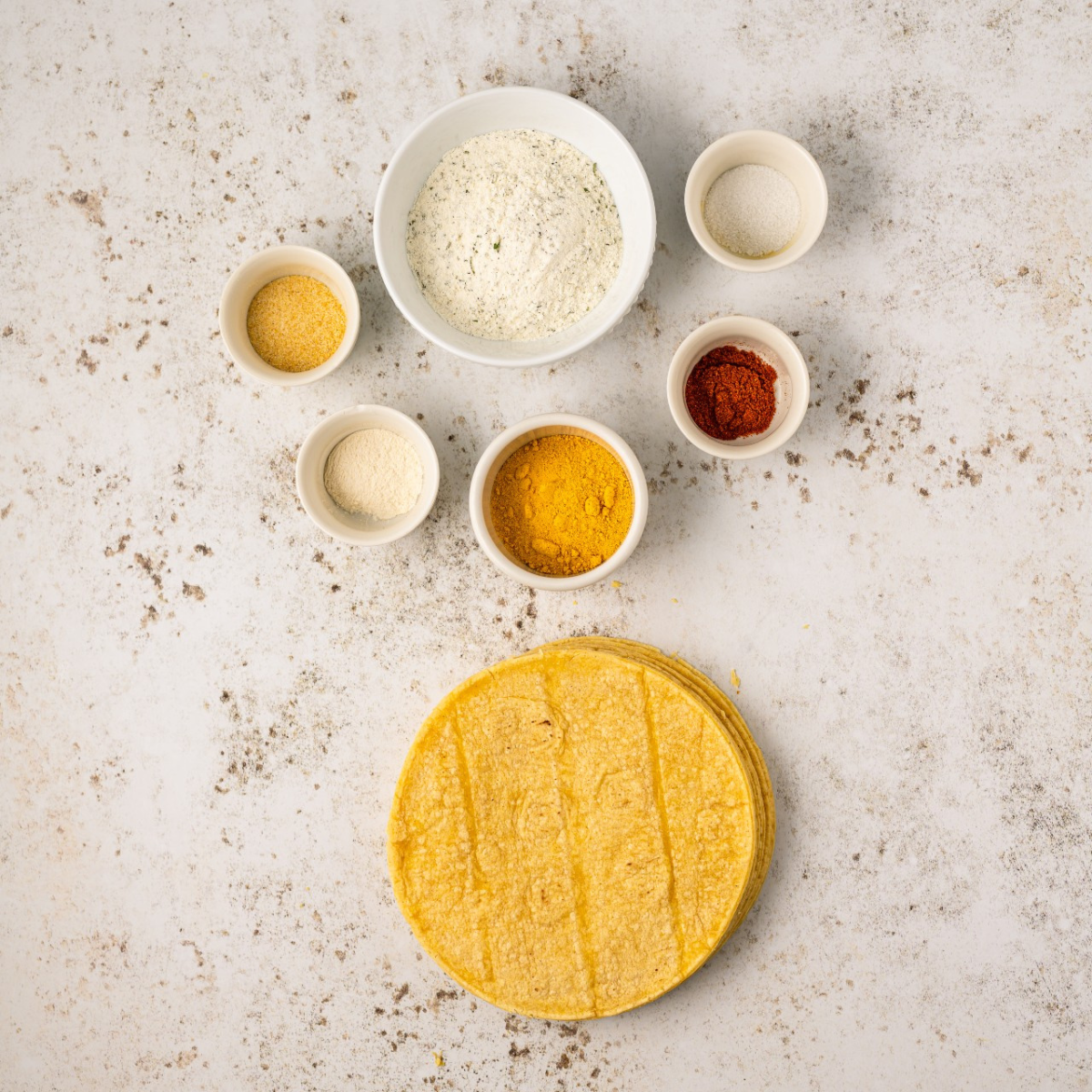 Ingredients for air fryer taco tortilla chips: tortillas, oil, and taco seasoning