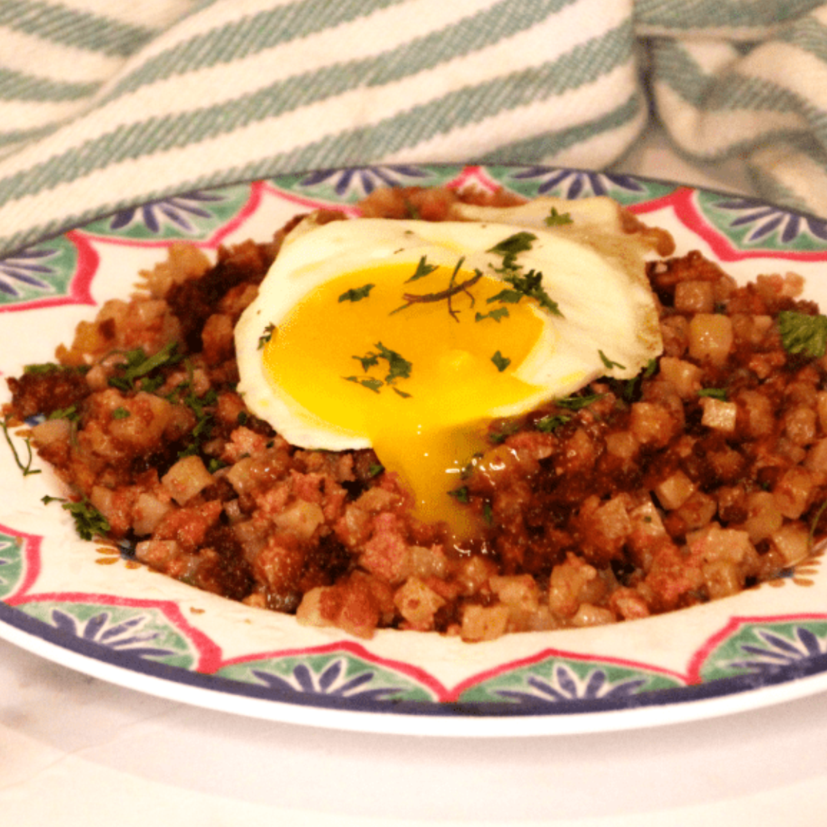 “Close-up of golden brown corned beef hash in air fryer basket”