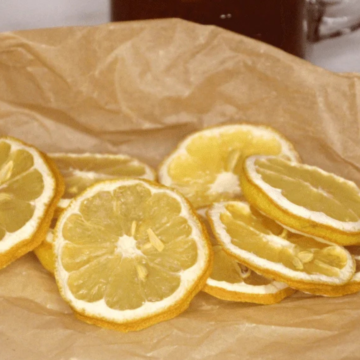 Air fryer dehydrated lemon slices arranged on a cooling rack, bright yellow citrus chips drying evenly.