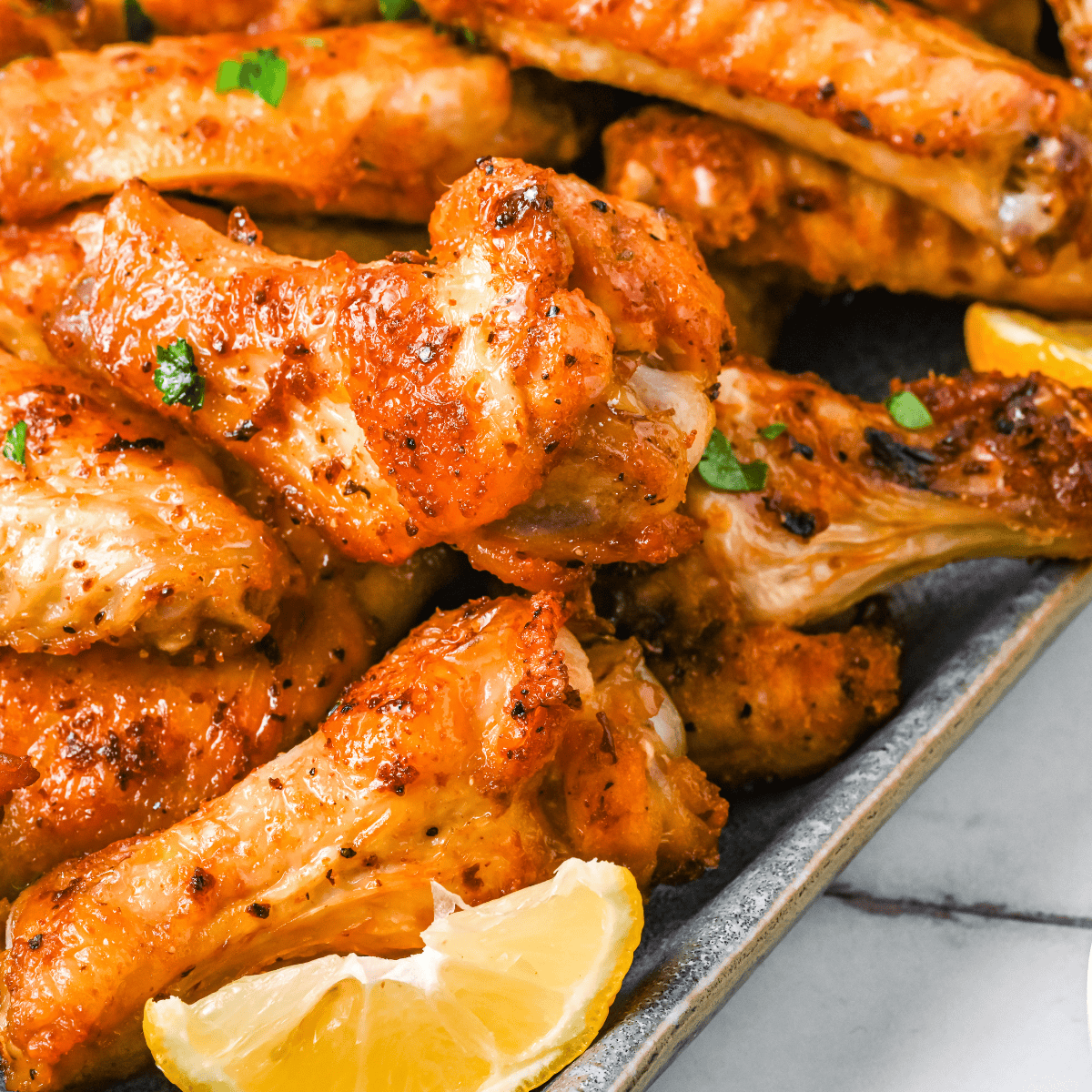 Plate of crispy Wingstop-style Hot Honey Rub chicken wings coated in sweet and spicy sauce.