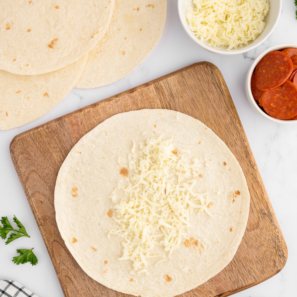 Stack of warm, soft tortillas on a plate, ready to serve.