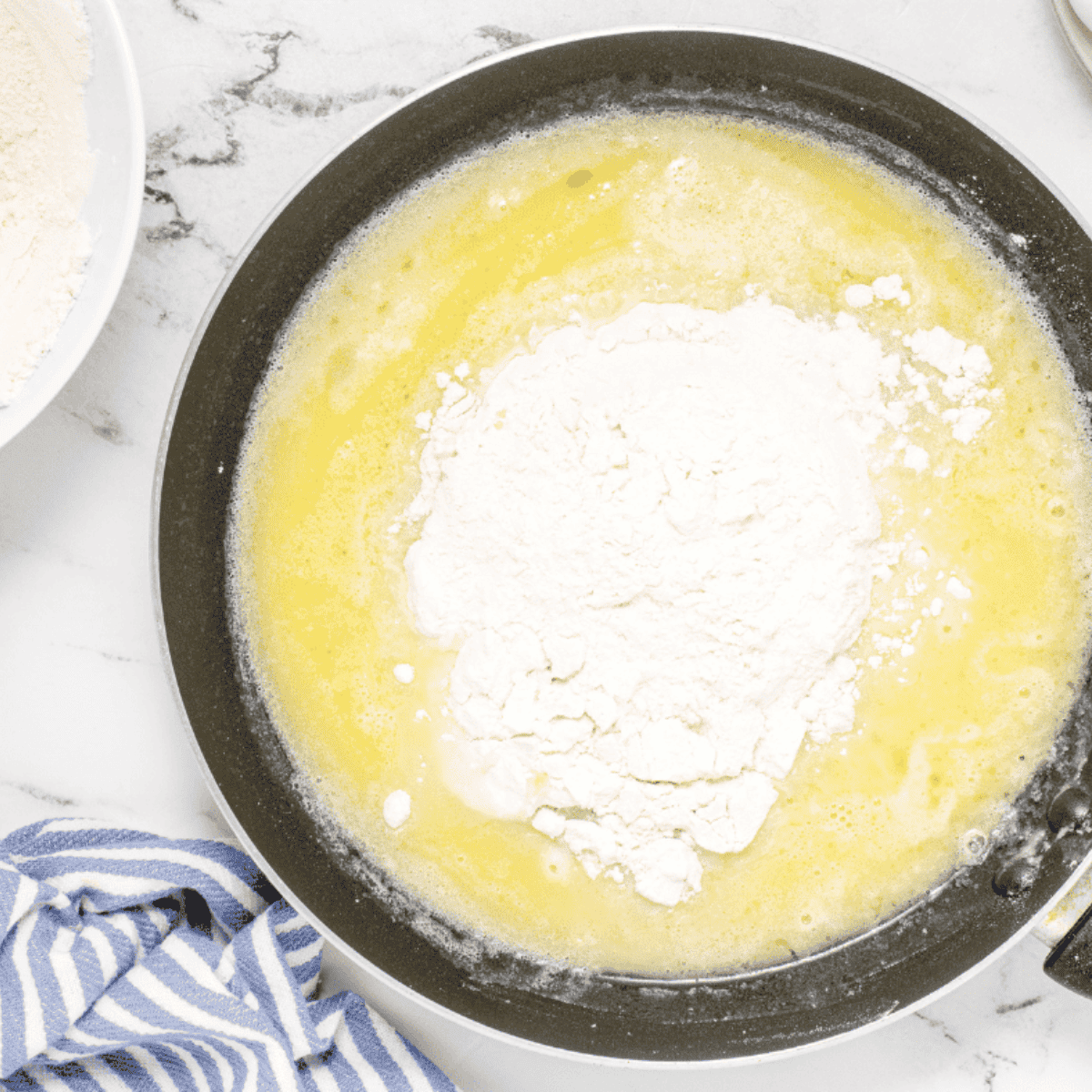Add the flour to the dough ingredients in a saucepean.