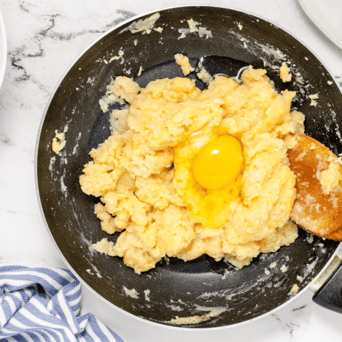 Slowly whisk in the egg to the donut dough.