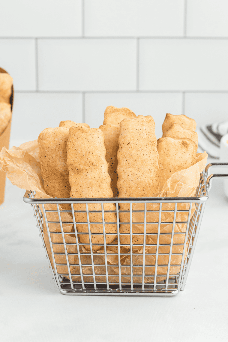 Plate of golden Snickerdoodle Cookie Fries sprinkled with cinnamon sugar, ready to serve.