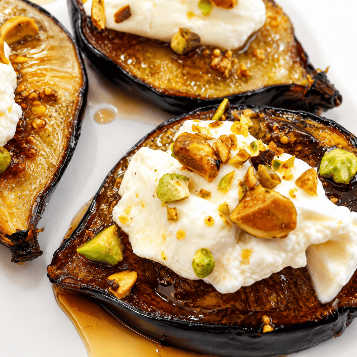 Air fryer roasted figs served over French toast with whipped cream on a white plate