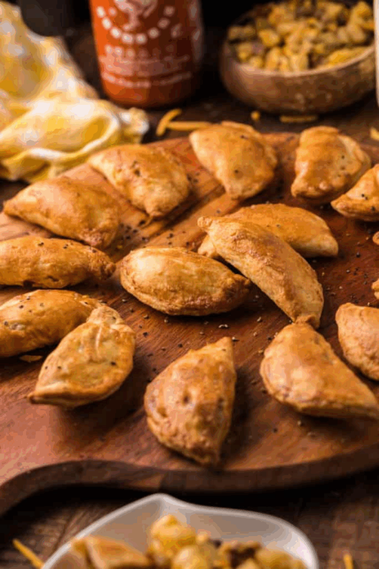 Golden flaky air fryer meat pies fresh from the fryer.