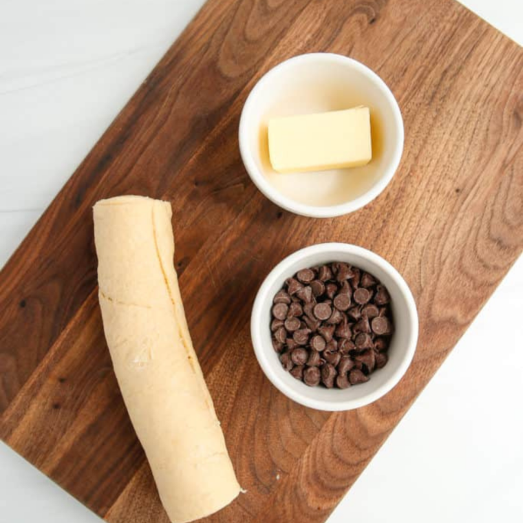 Ingredients for air fryer peanut butter chocolate crescent rolls: crescent roll dough, peanut butter, chocolate chips, and butter