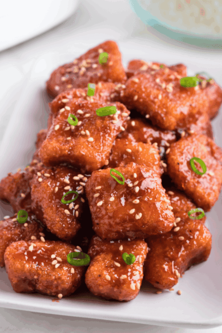 Air fryer teriyaki salmon bites coated in golden, sticky glaze