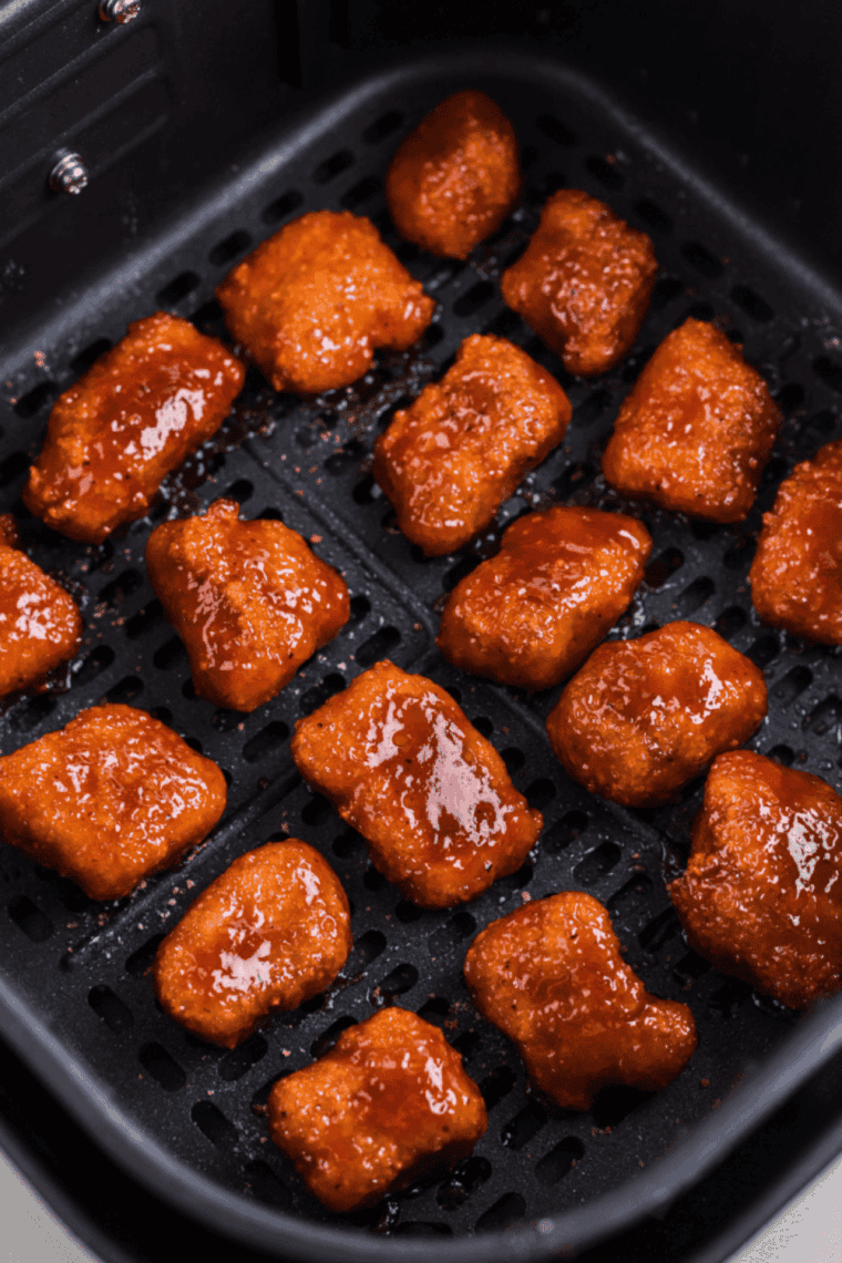 Air fryer teriyaki salmon bites coated in golden, sticky teriyaki glaze