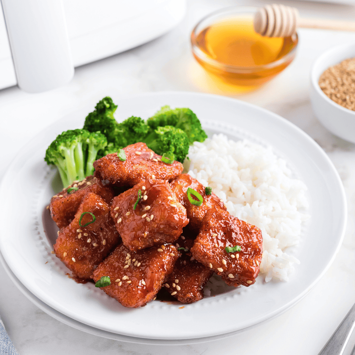 Air fryer teriyaki salmon bites coated in sticky, golden-brown glaze