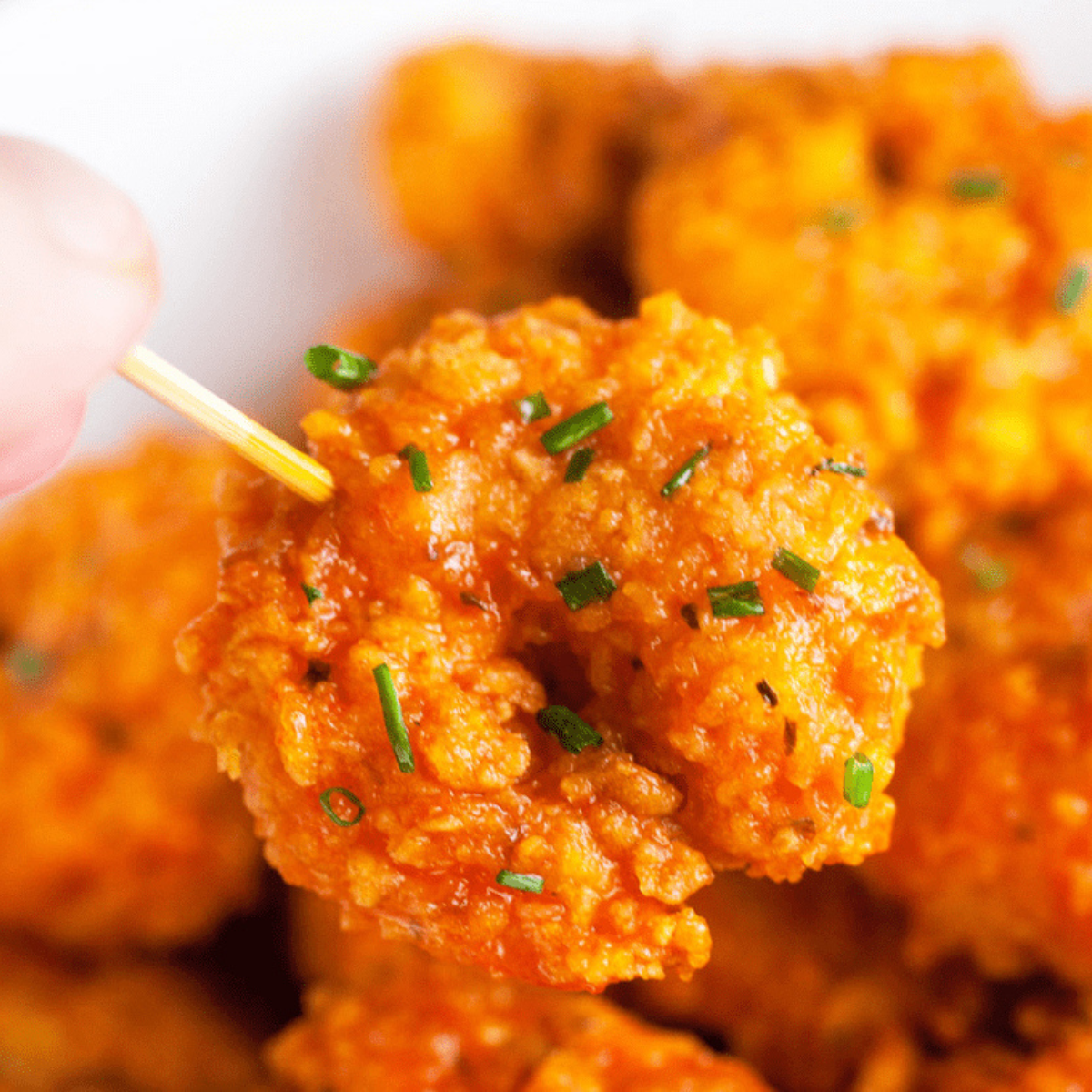 Air fryer buffalo shrimp coated in spicy Hooters-style sauce, served with celery and blue cheese dip.