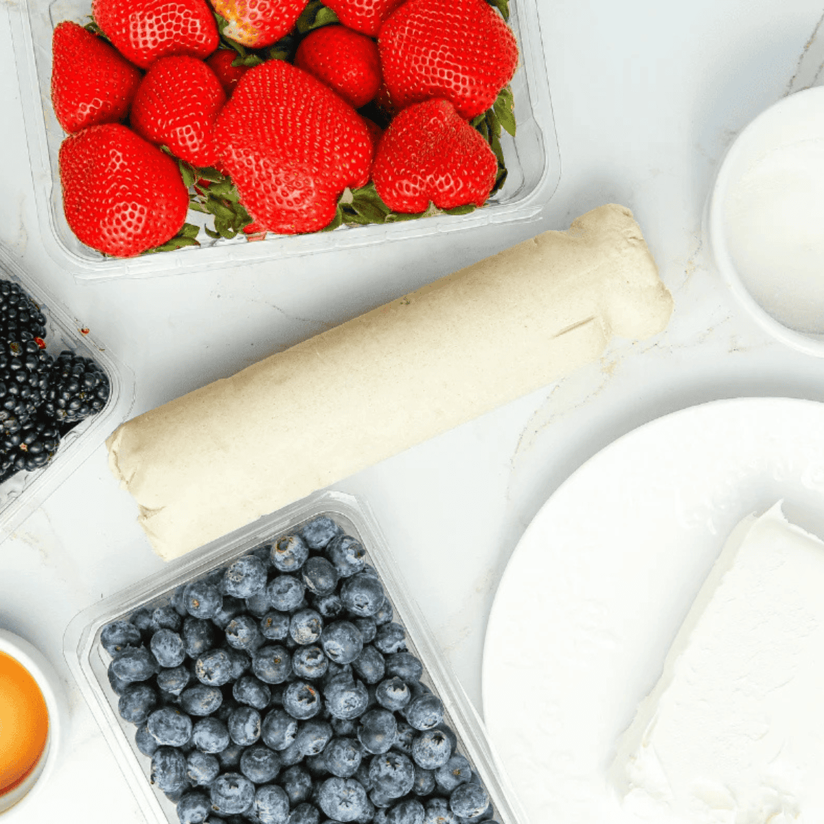 Ingredients needed for Air Fryer Sugar Fruit Pizza on kitchen table.