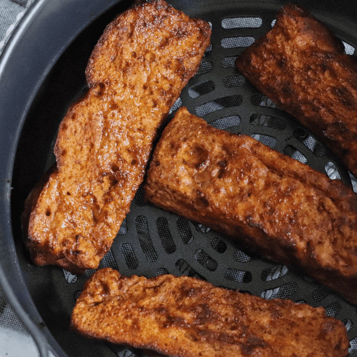 Golden Ninja Foodi French Toast slices on a plate