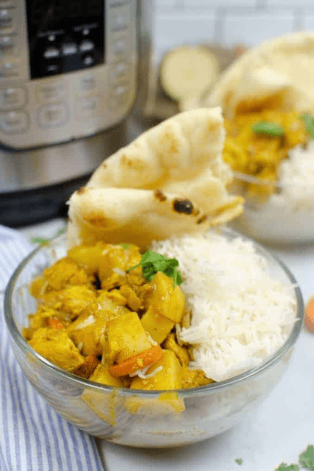 Slow Cooker Chicken Curry in a white bowl with coconut sauce and spices