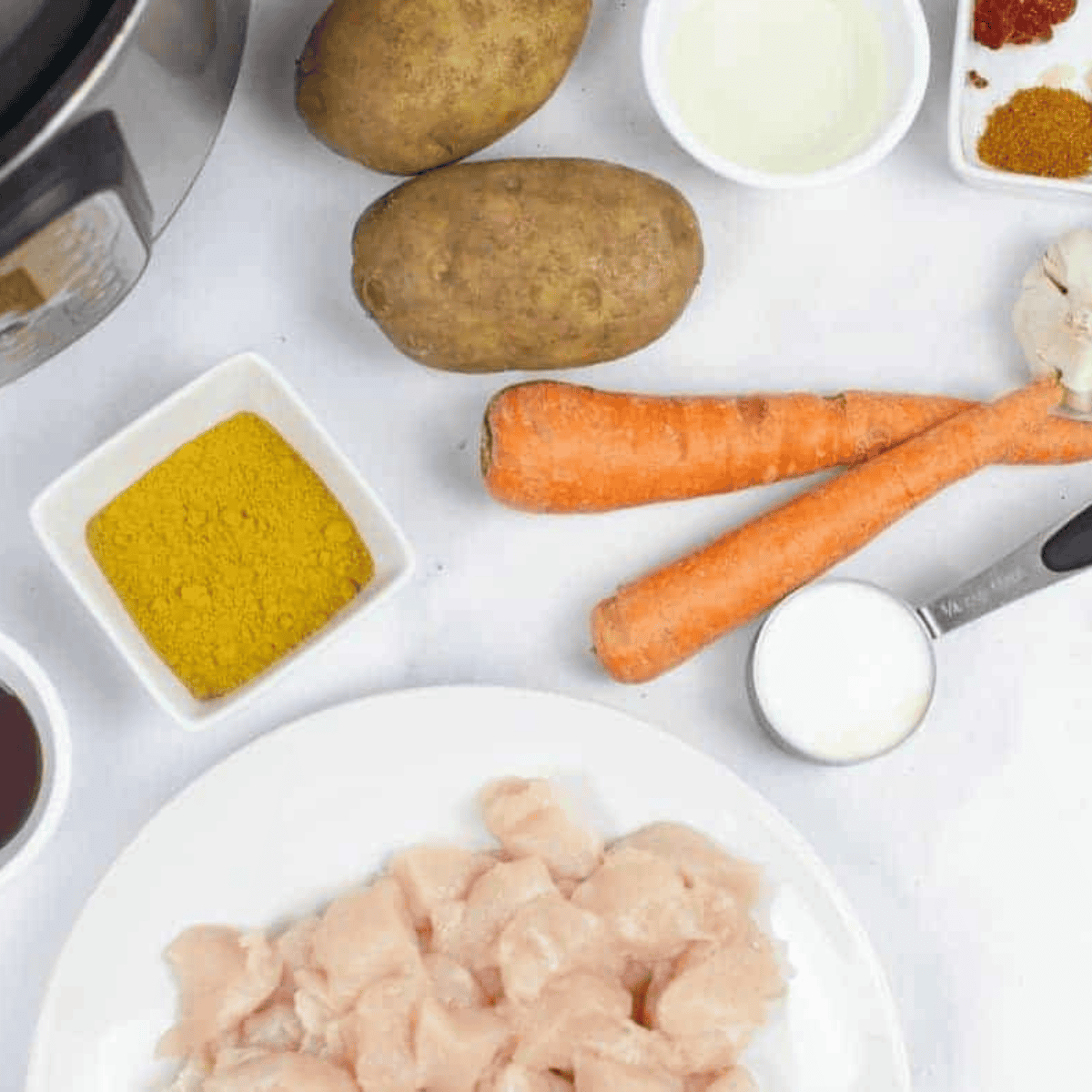 Ingredients needed for Slow Cooker Easy Chicken Curry on kitchen table.