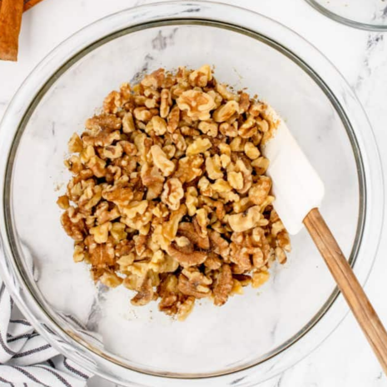 Air fryer basket preheating at 320°F with parchment paper lining, prepared for honey roasted walnuts.