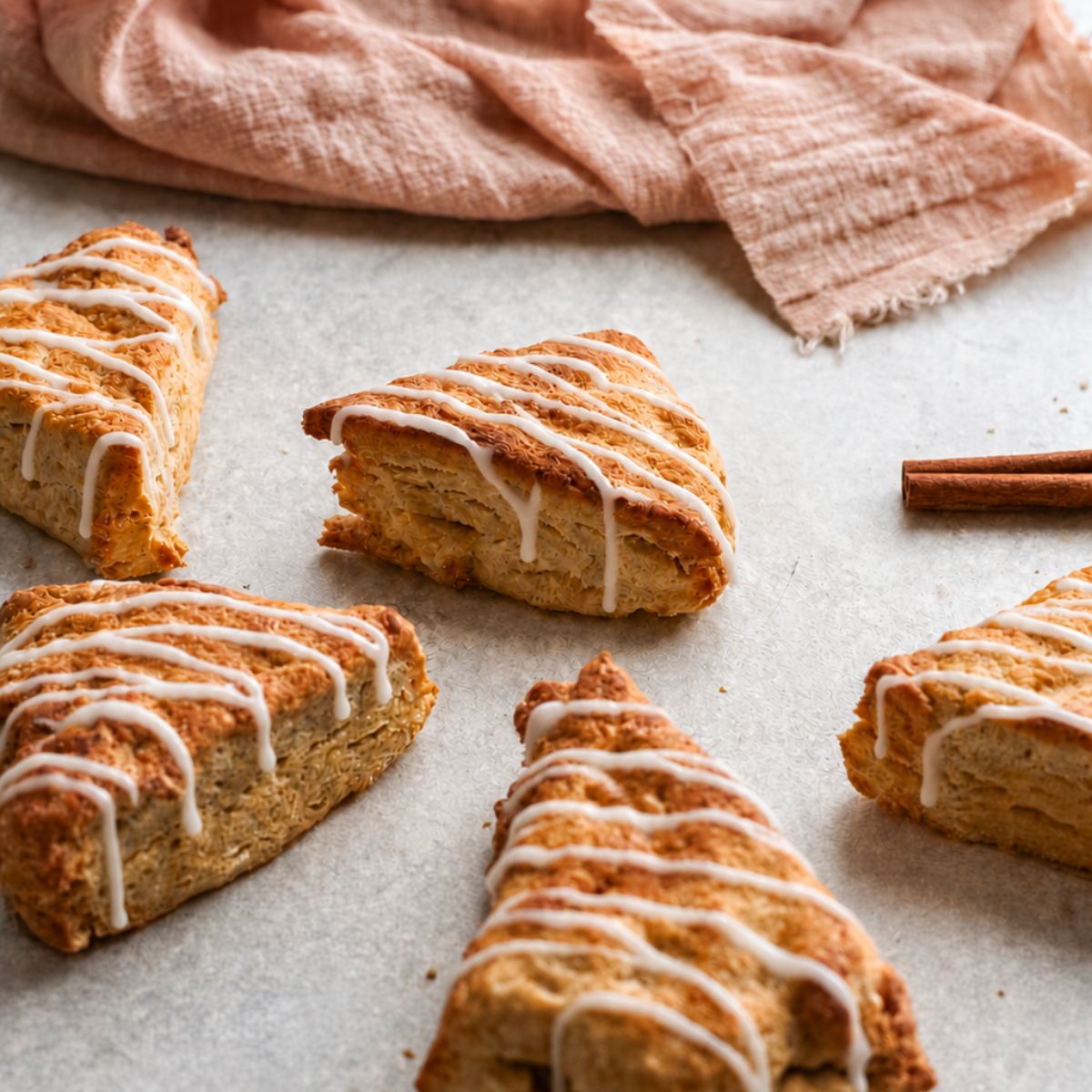 Eight golden air fryer apple scones cooling on a wire rack