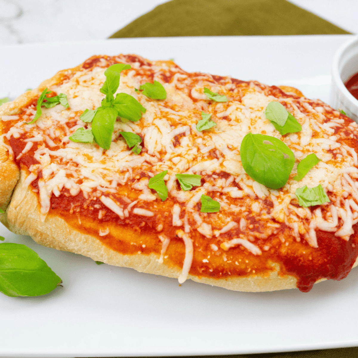 Air Fryer Chicken Parmesan Calzone with golden crust, stuffed with juicy chicken, marinara sauce, and melted cheese.