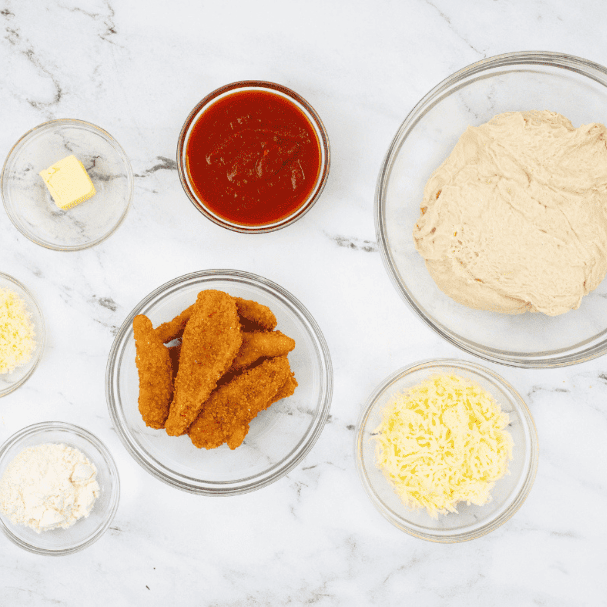 Ingredients needed for Air Fryer Chicken Parmesan Calzone on kitchen table.