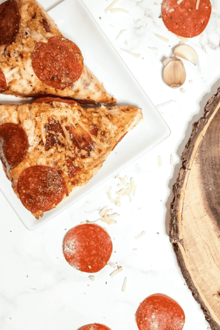 Close-up of melted mozzarella stretching from a slice of air fryer copycat Pizza Hut pan pizza