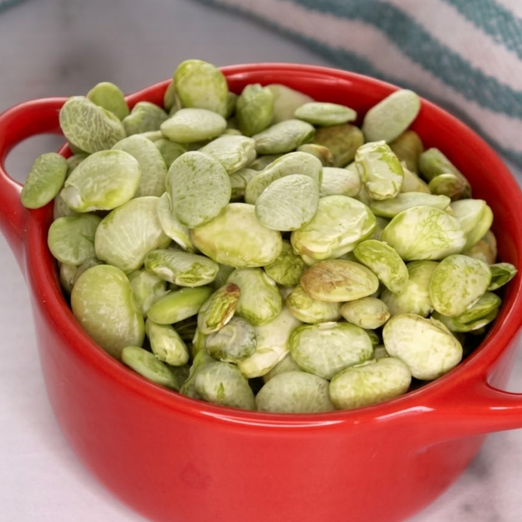 Crispy air fryer frozen lima beans served in a white bowl with seasoning
