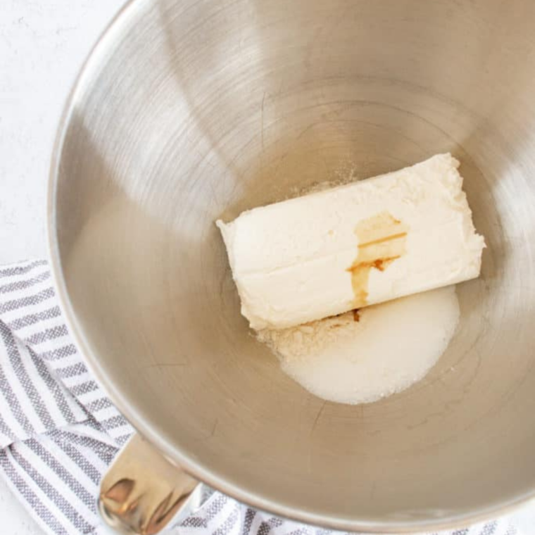 Cream cheese Danish filling beaten smooth in a glass mixing bowl with a hand mixer