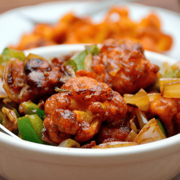 Crispy air fryer cauliflower tossed in glossy teriyaki sauce, served hot.