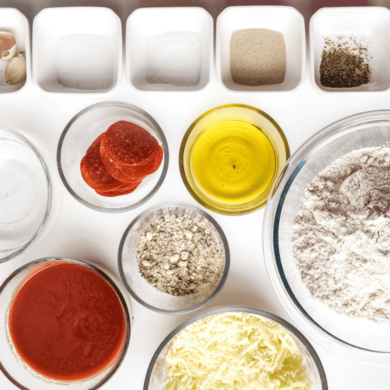 Ingredients needed for Easy Little Caesar’s Pizza Sauce Recipe on kitchen table.