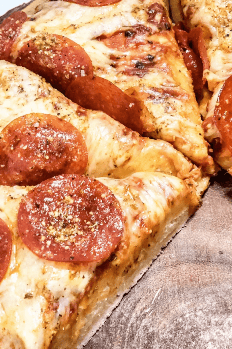 Bowl of smooth, homemade Little Caesar’s pizza sauce ready to spread on pizza crust