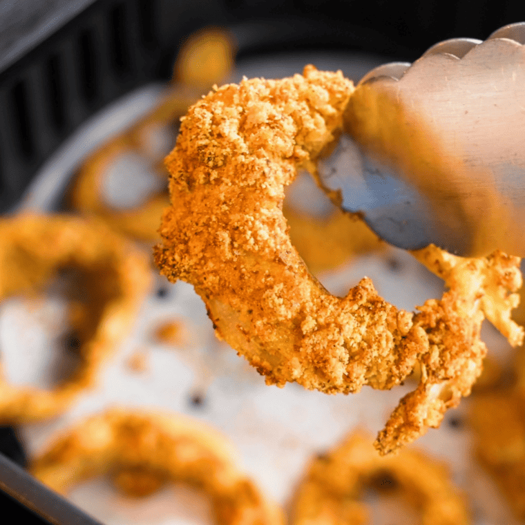 Close-up of a crispy golden Red Robin onion ring after cooking in the air fryer, showing the crunchy breaded coating