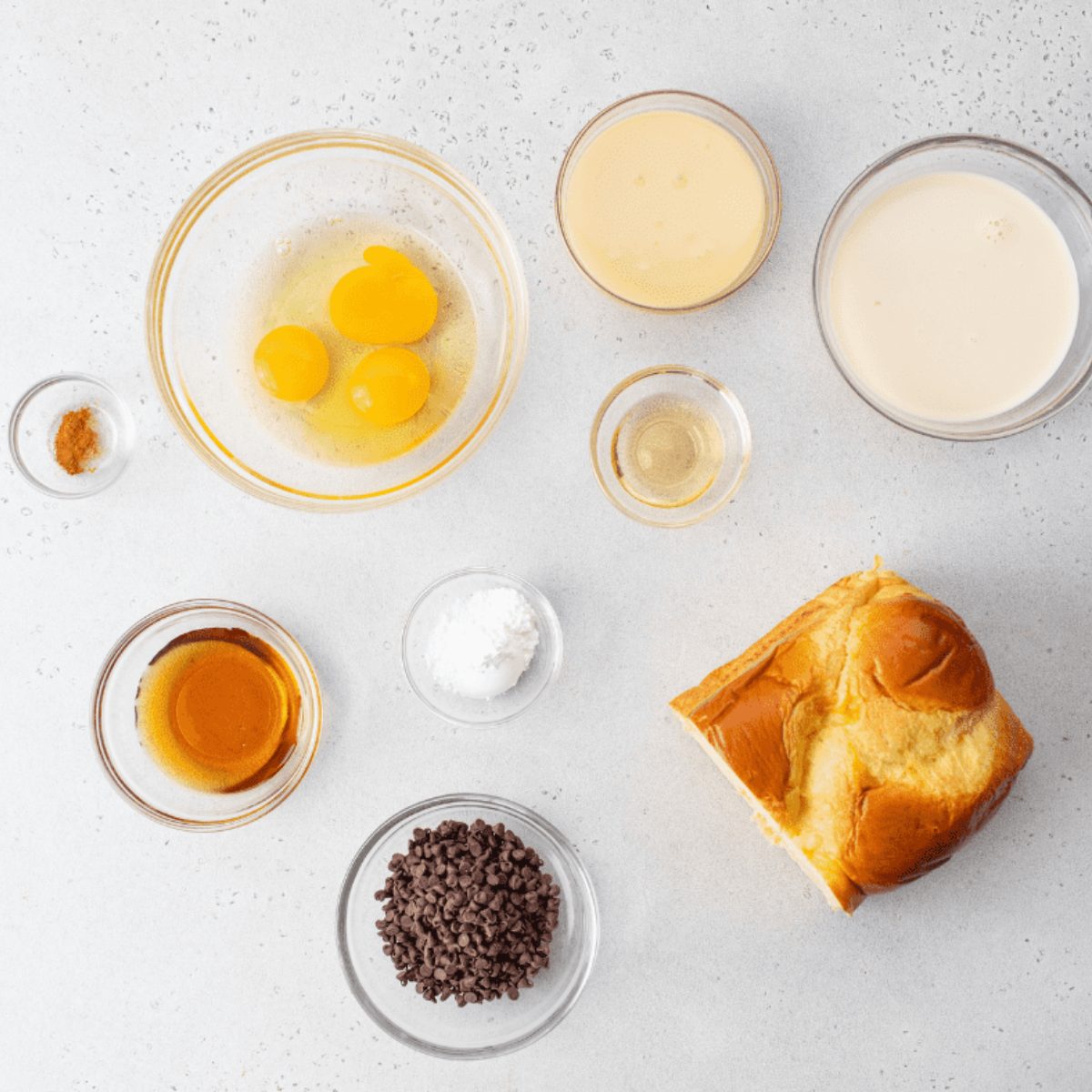 Ingredients needed for Air Fryer Chocolate Chip French Toast Casserole on kitchen table.
