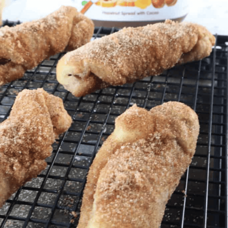 Air fryer Nutella stuffed churros coated in cinnamon sugar on plate