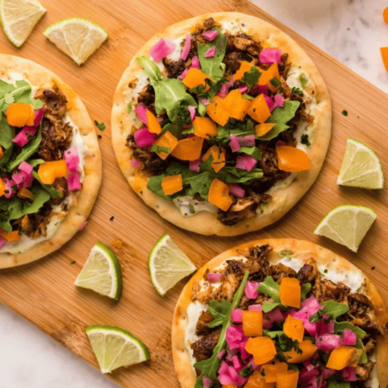 Two salmon flatbreads on a dinner table set for a casual meal