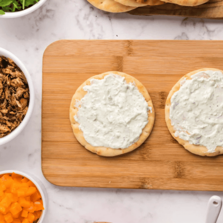 Naan flatbread spread with garlic-herb cream cheese