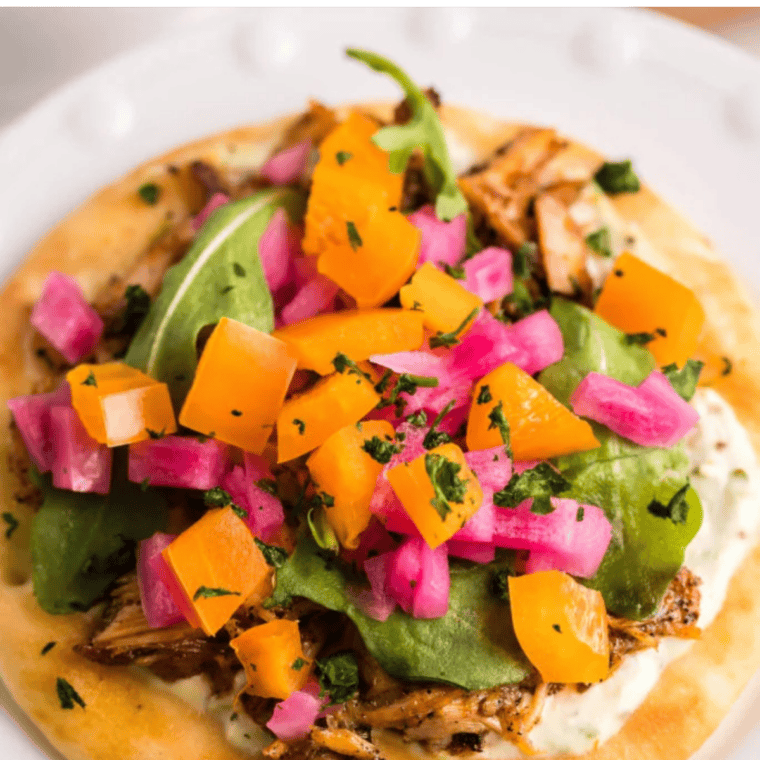 Air fryer salmon flatbread served with a side arugula salad and white wine