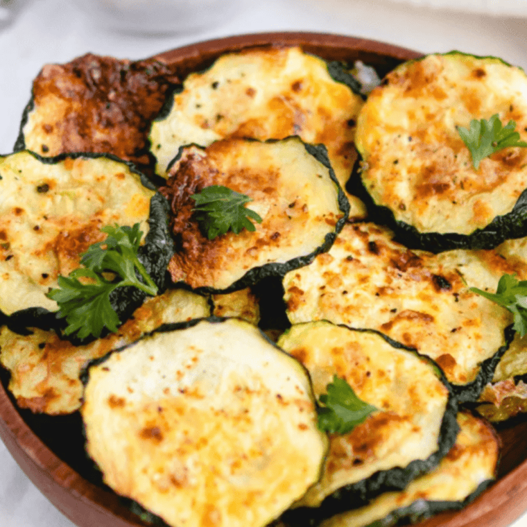 Crispy dehydrated zucchini slices made in an air fryer, ready to eat.