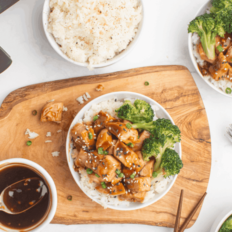 Air Fryer Teriyaki Chicken Bowl with tender chicken, colorful steamed vegetables, and white rice drizzled with teriyaki sauce.