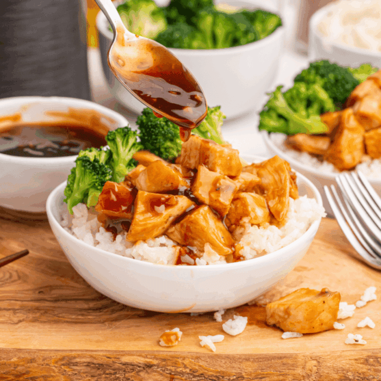 Air Fryer Teriyaki Chicken Bowl with juicy chicken, steamed vegetables, and white rice in a bowl, drizzled with teriyaki sauce.