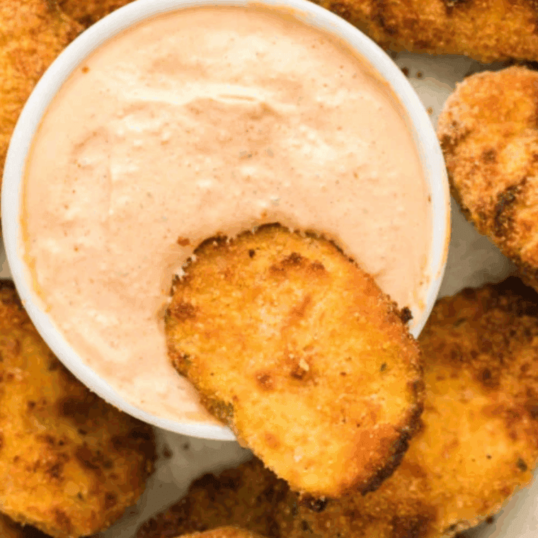 Golden brown air fryer Hooters fried pickles fresh from the basket on a white plate