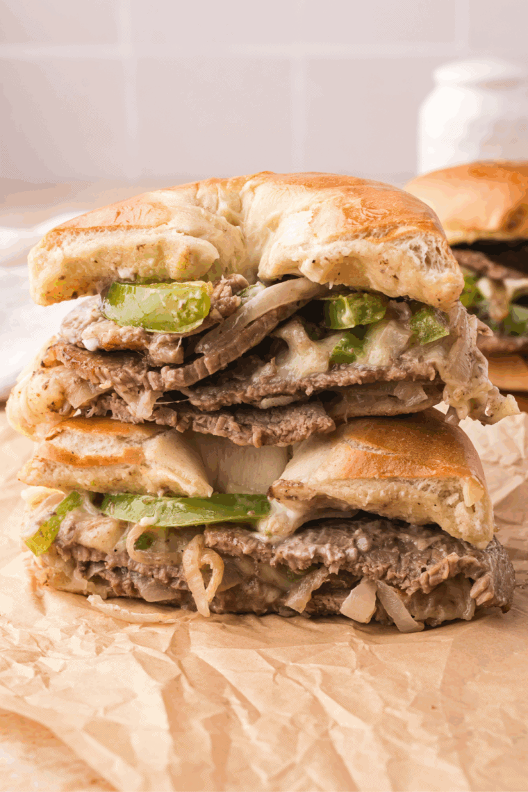 Ribeye steak sandwich with caramelized onions and melted cheese on a toasted hoagie roll.