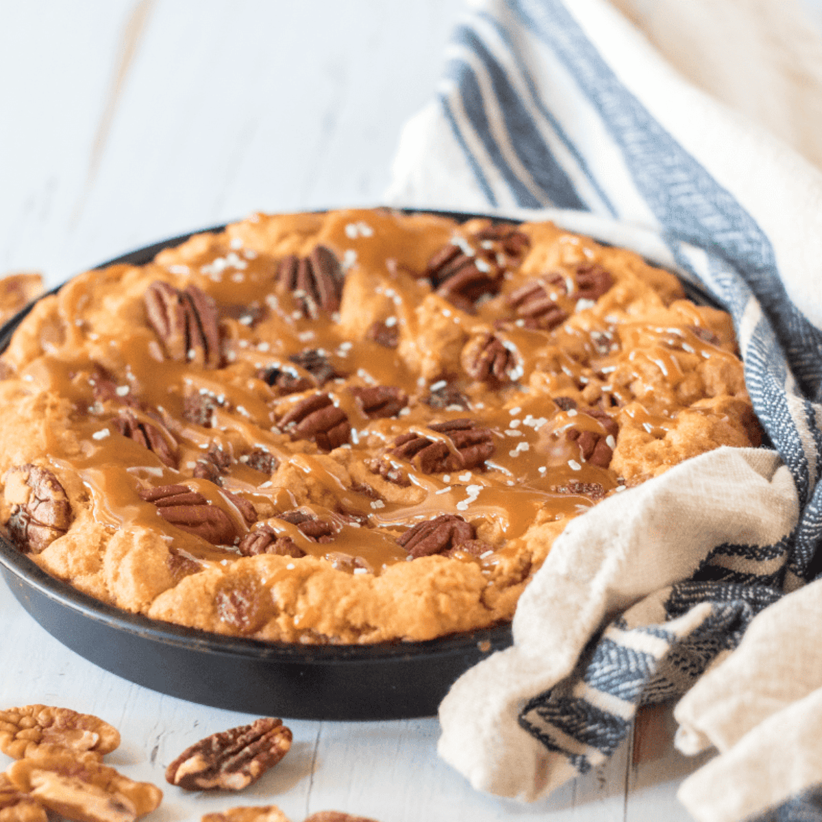 Giant Caramel Pecan Cookie fresh from the air fryer, golden brown with melted caramel and toasted pecans.