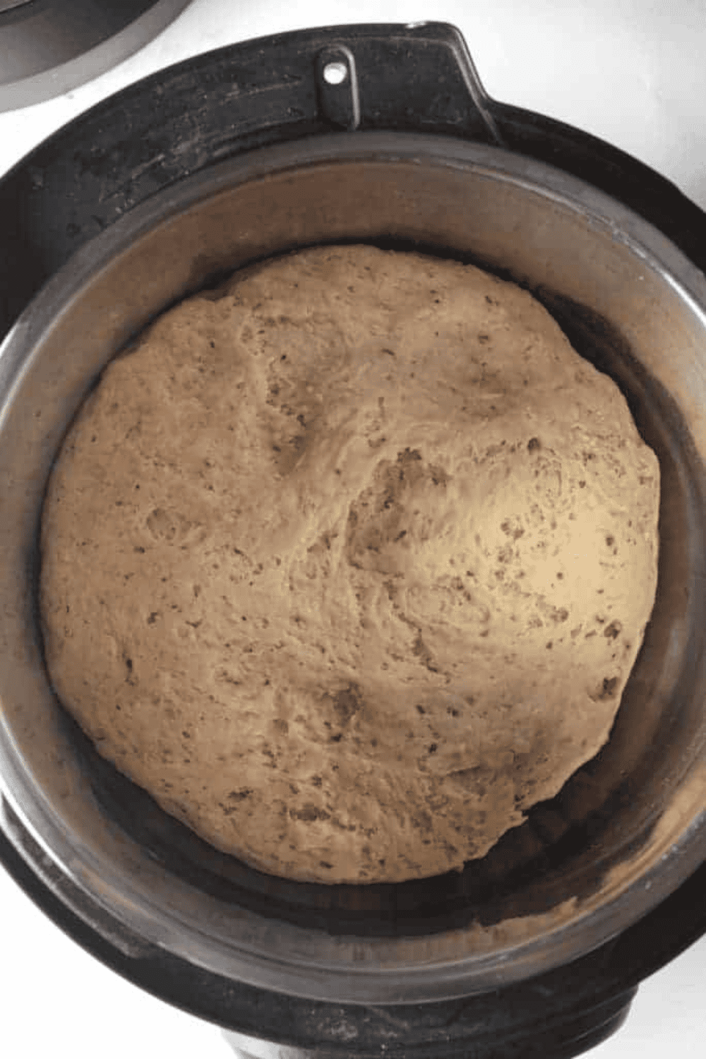 Focaccia dough rising in the Instant Pot on the Yogurt setting until it doubles in size.