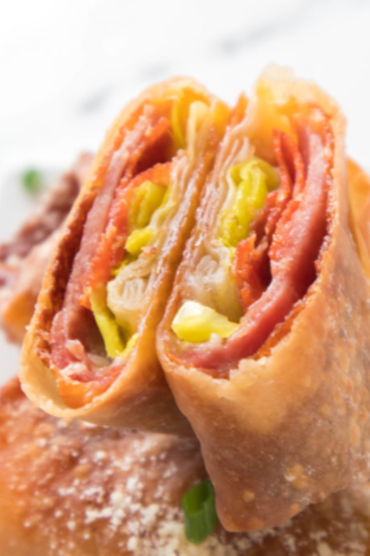 Close up of air fryer antipasto egg rolls showing the crisp blistered wrapper