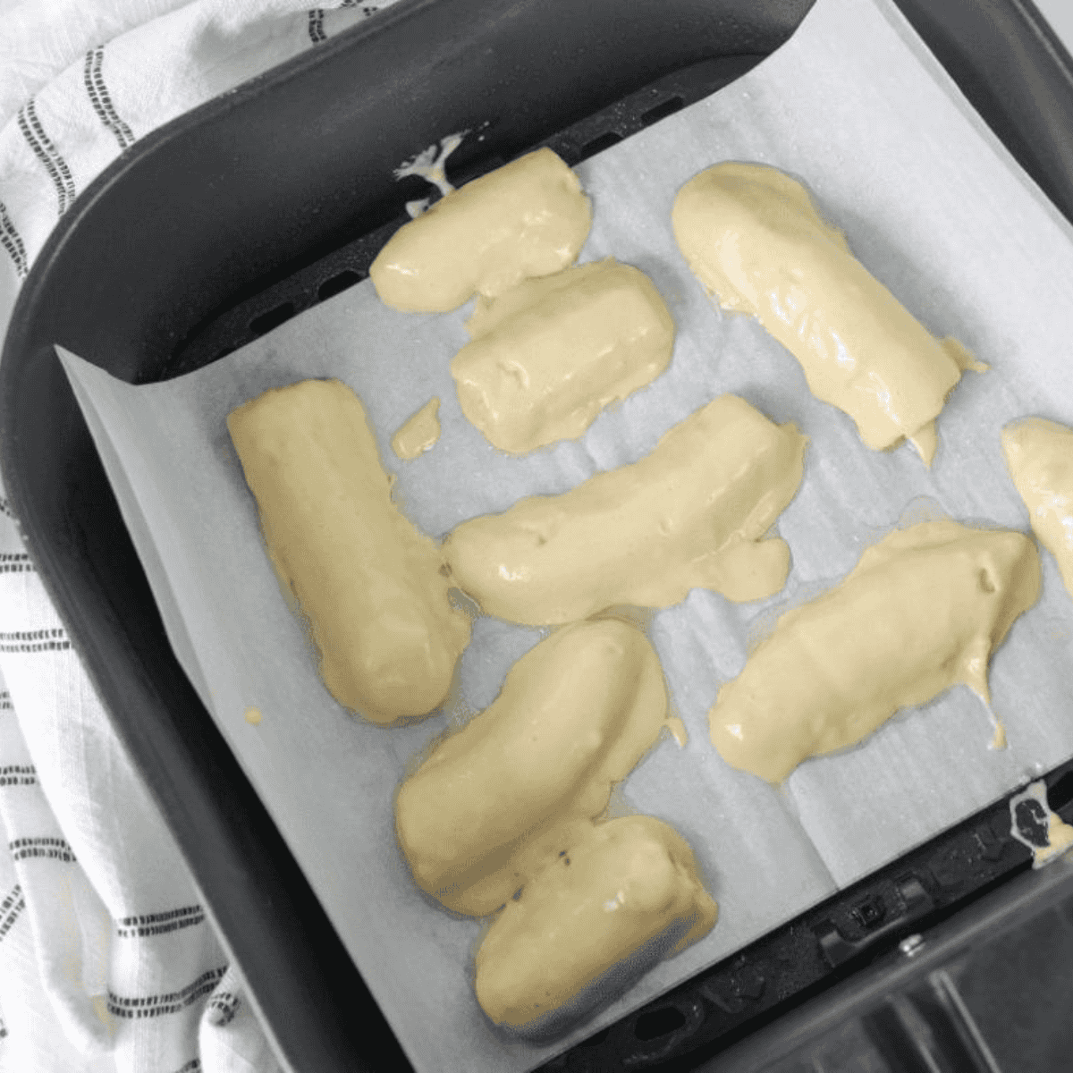 Air frying banana pancake dippers at 350°F until golden brown, flipping halfway through cooking.