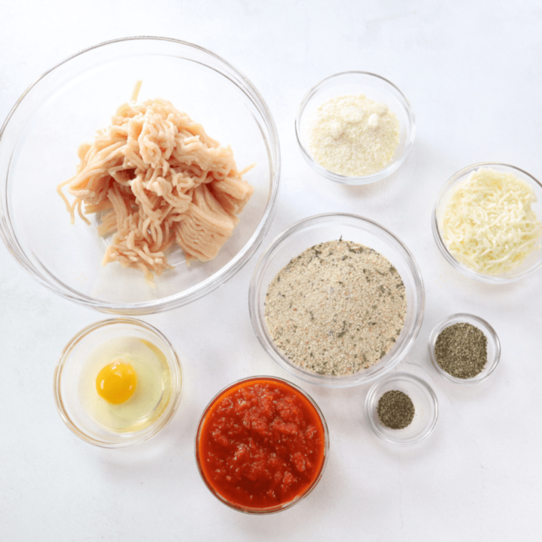 Ground chicken, panko, milk, Parmesan, egg, olive oil and seasonings measured in glass bowls